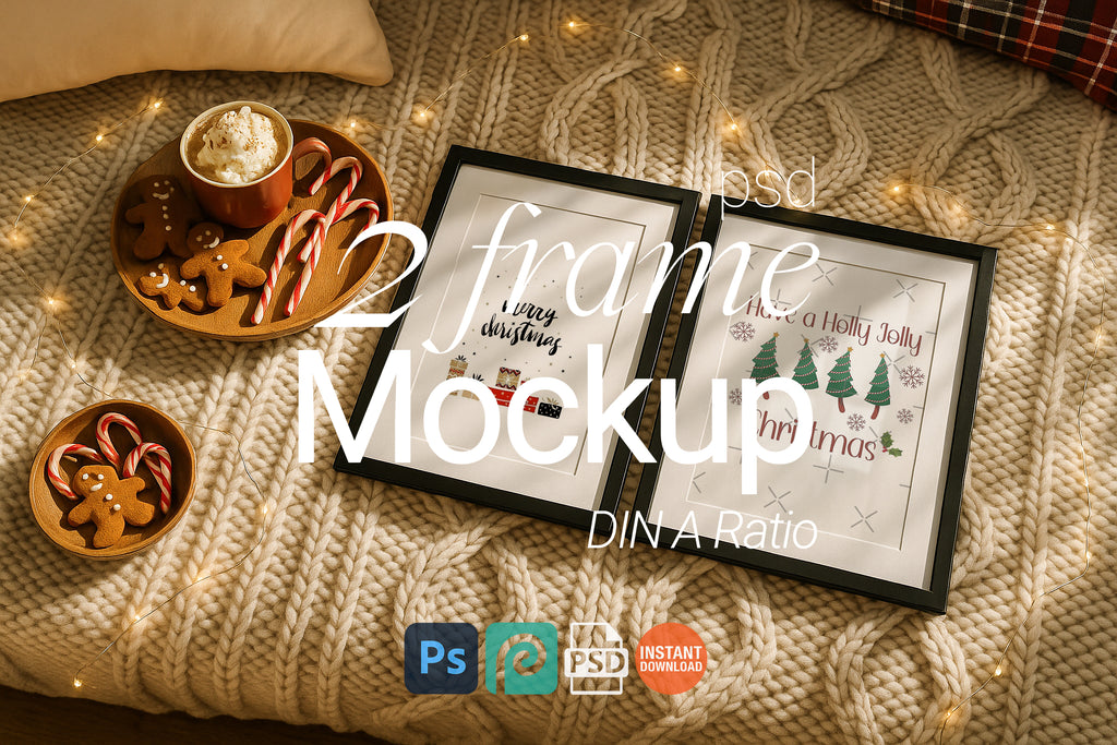 Two black picture frames on a chunky knit blanket styled with Christmas gingerbread cookies, candy canes, fairy lights, and hot cocoa for a festive holiday scene.