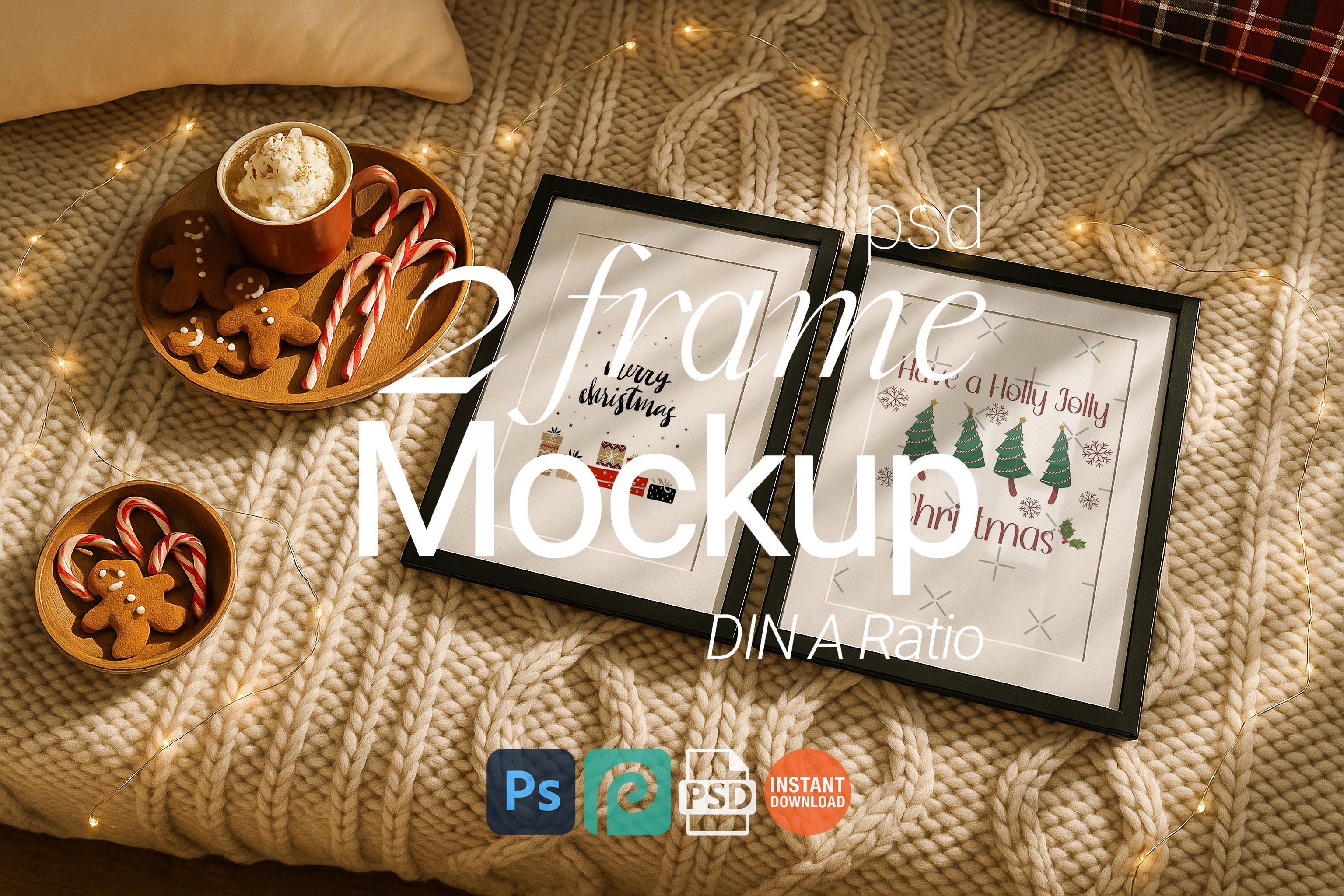 Two black picture frames on a chunky knit blanket styled with Christmas gingerbread cookies, candy canes, fairy lights, and hot cocoa for a festive holiday scene.